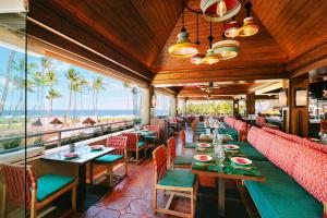 a restaurant with tables and chairs and a view of the ocean at Grand Wailea Resort Hotel & Spa, A Waldorf Astoria Resort in Wailea