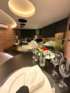 a dining room with a table with plates and wine glasses at Hotel Motel Paradiso - Panambi-RS in Tabapira +8 photos