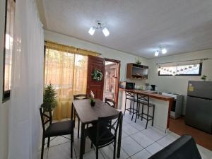 a kitchen and dining room with a table and chairs at Tulip House in Comayagua +11 photos