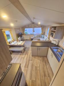 an aerial view of a kitchen and living room of a caravan at Whitstable Hollington in Seasalter