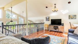 a living room with a couch and a television at Harborview Getaway by AvantStay in Langley