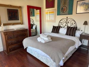 a bedroom with a large bed and a dresser at Beautiful Apartment Teatro Cervantes in Málaga