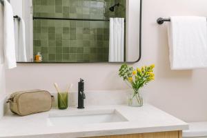 a bathroom with a sink and a mirror at LIVN West Loop Chicago Classic Queen Studio in Chicago