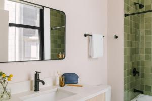a bathroom with a sink and a mirror at LIVN West Loop Chicago Queen Superior Studio in Chicago