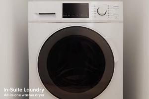 a white washing machine with a black door at LIVN West Loop Chicago Queen Superior Studio in Chicago +11 photos