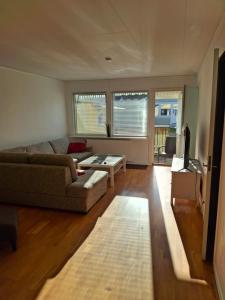 a living room with a couch and a table at bekväm villa in Fliseryd