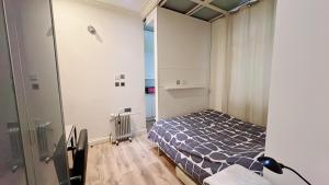 a small bedroom with a bed in a room at Soho China Town Rooms in London