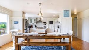 a kitchen and dining room with a wooden table at Bayview Together Farm by AvantStay in Clinton