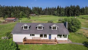 an aerial view of a white house with a porch at Bayview Together Farm by AvantStay in Clinton