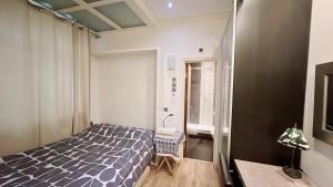 a bedroom with a blue and white bed and a window at Soho China Town Rooms in London