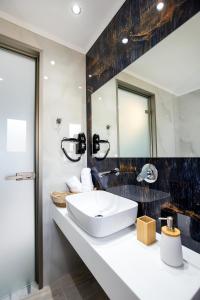 a bathroom with a sink and a mirror at East Coast in Alyki +82 photos