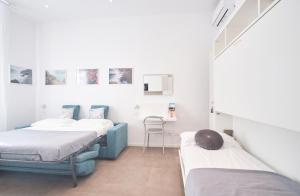 a room with two beds and a desk at Casa Contra in La Spezia