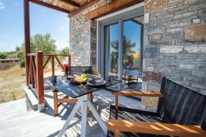 a table on the deck of a stone house at East Coast in Alyki