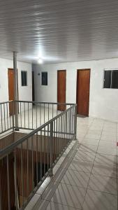 an empty room with wooden doors in a building at Hotel Globo in Goiânia