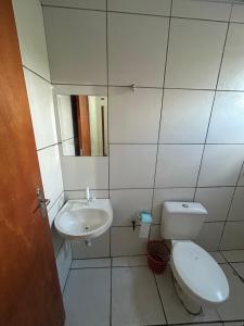 a small bathroom with a toilet and a sink at Hotel Globo in Goiânia
