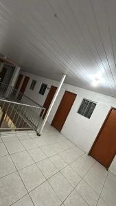 a room with doors and a staircase in a building at Hotel Globo in Goiânia