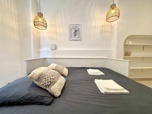 a bed with two pillows and two towels on it at Casa Sauge in Grasse