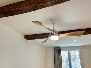 a ceiling fan in a room with a window at Casa Sauge in Grasse +9 photos