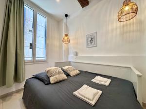 a bedroom with a bed with two pillows on it at Casa Sauge in Grasse