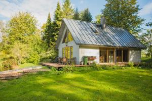 a small house with a porch and a deck at Mokko Country Hotel in Palamuse