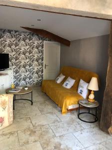 a bedroom with a bed and two tables in a room at Locéane in Le Pêchereau