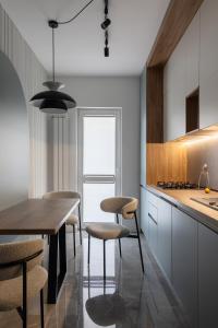 a kitchen with a table and some chairs and a counter at The Aristocrat by D'or Selection in Bucharest +9 photos