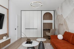 a living room with a couch and a table at The Aristocrat by D'or Selection in Bucharest