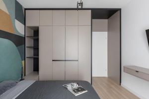 a bedroom with a bed and a white closet at The Aristocrat by D'or Selection in Bucharest