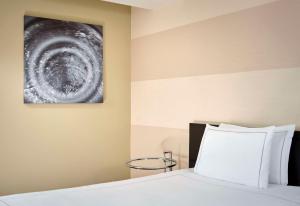 a bedroom with a bed and a painting on the wall at Park Plaza Leeds in Leeds