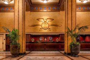 a lobby of a hotel with a sign on the wall at The Roosevelt Hotel New Orleans - Waldorf Astoria Hotels & Resorts in New Orleans