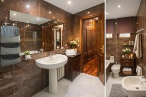 a bathroom with a sink and a toilet and a mirror at Villa Lestedo in Lestedo