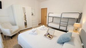 a bedroom with two bunk beds and a bed with a box of towels at Appartamento estivo PONENTE - Misano Adriatico -RN- in Misano Adriatico