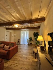 a living room with a couch and a tv at Dimore Romeo - La Dimora del Corso in Montecastrilli +13 photos