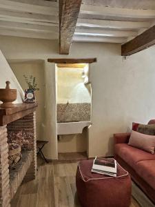 a living room with a red couch and a fireplace at Dimore Romeo - La Dimora del Corso in Montecastrilli