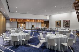 a conference room with white tables and chairs at Conrad New York Downtown in New York