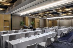 a conference room with white tables and chairs at Conrad New York Downtown in New York