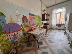 a living room with a painting on the wall at Nomads Nest in Kutaisi