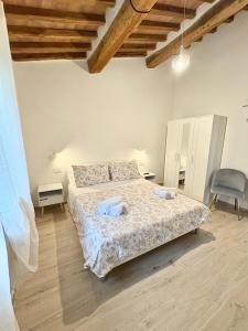 a bedroom with a bed and a chair at Agriturismo Colle Sereno in Castiglione dʼOrcia +31 photos