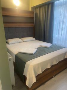a bedroom with a bed with two towels on it at Başkent Otel in Mudanya +1 photo