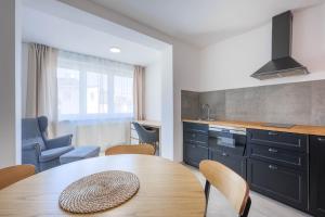 a kitchen and dining room with a table and chairs at Penzion U Leopolda in Brno