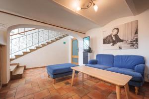 a living room with a blue couch and a table at Penzion U Leopolda in Brno