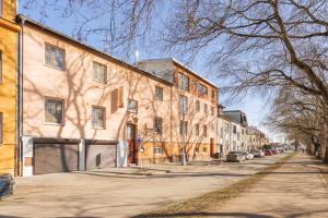 a large building on a street with cars parked on the side at Penzion U Leopolda in Brno