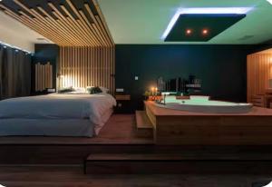 a bedroom with a large bed and a bath tub at Loveroom Lens in Lens