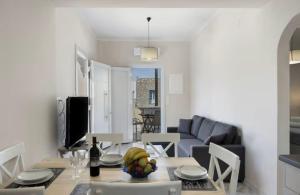 a living room with a table and a couch at Sunset Realty in Ano Syros