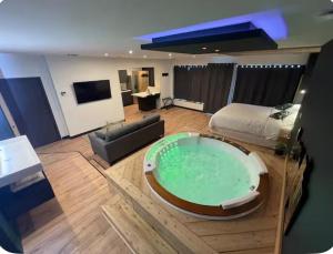a hotel room with a large tub in the middle of the room at Loveroom Lens in Lens