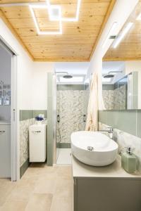 a bathroom with a sink and a shower at Respiro di Chiaia in Procida