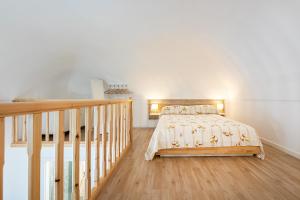 a bedroom with a bed and a staircase at Respiro di Chiaia in Procida