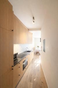 a kitchen with wooden cabinets and a sink at The White Boutique Loft in Antwerp