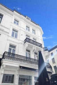 a white building with a balcony on a street at The White Boutique Loft in Antwerp