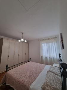 a bedroom with a large bed and a window at Casa Vanda in San Lorenzo +3 photos